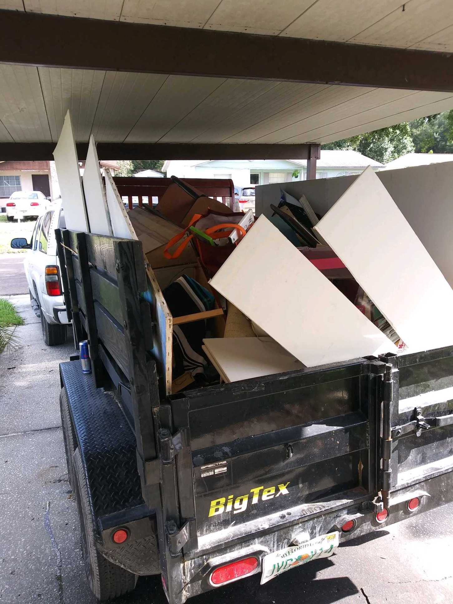 Junk Busters trailer hauling cabinets furniture and bulky household material in Tampa Bay