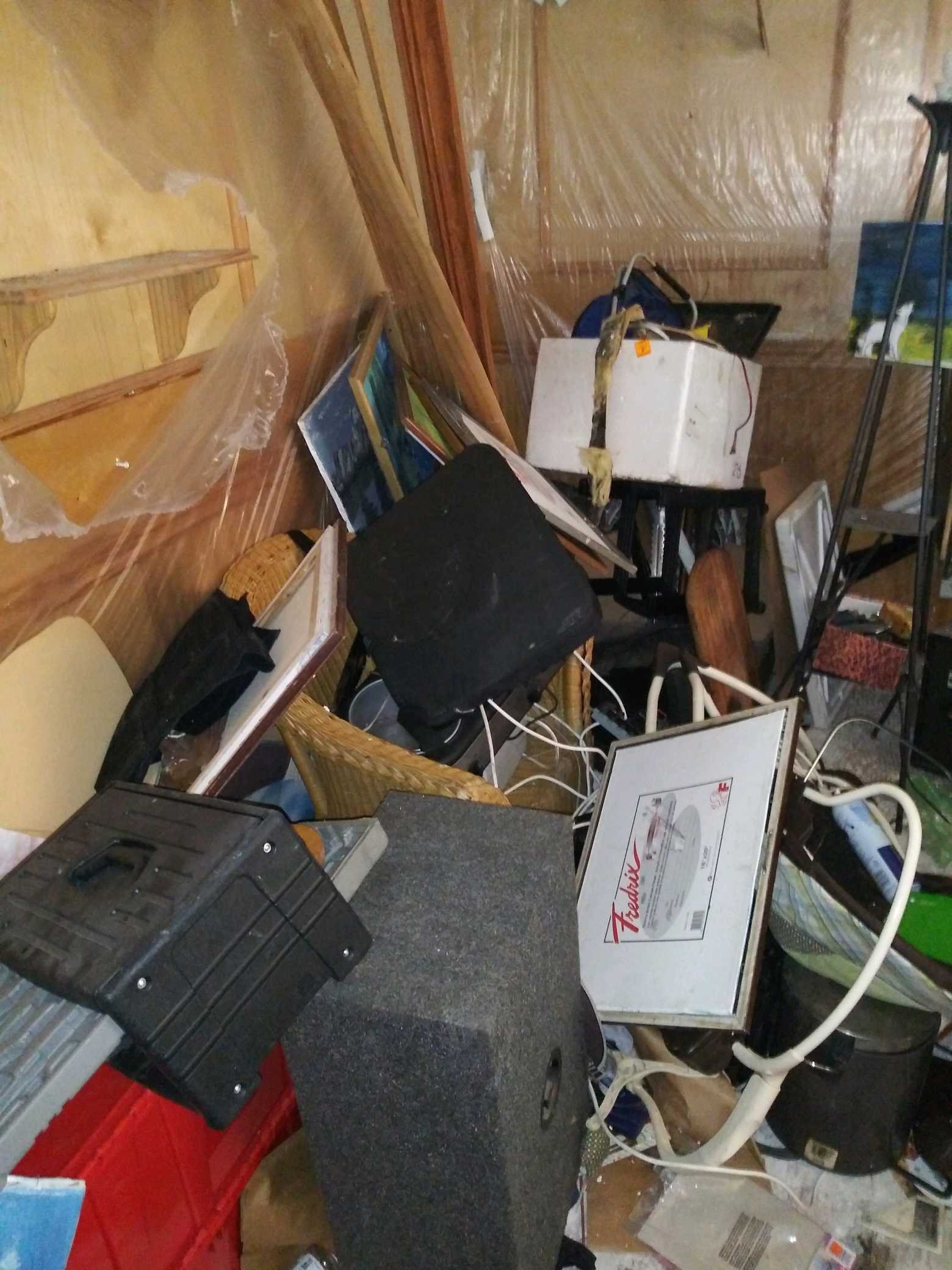 Dense household clutter documented before a Junk Busters heavy-cleanout project