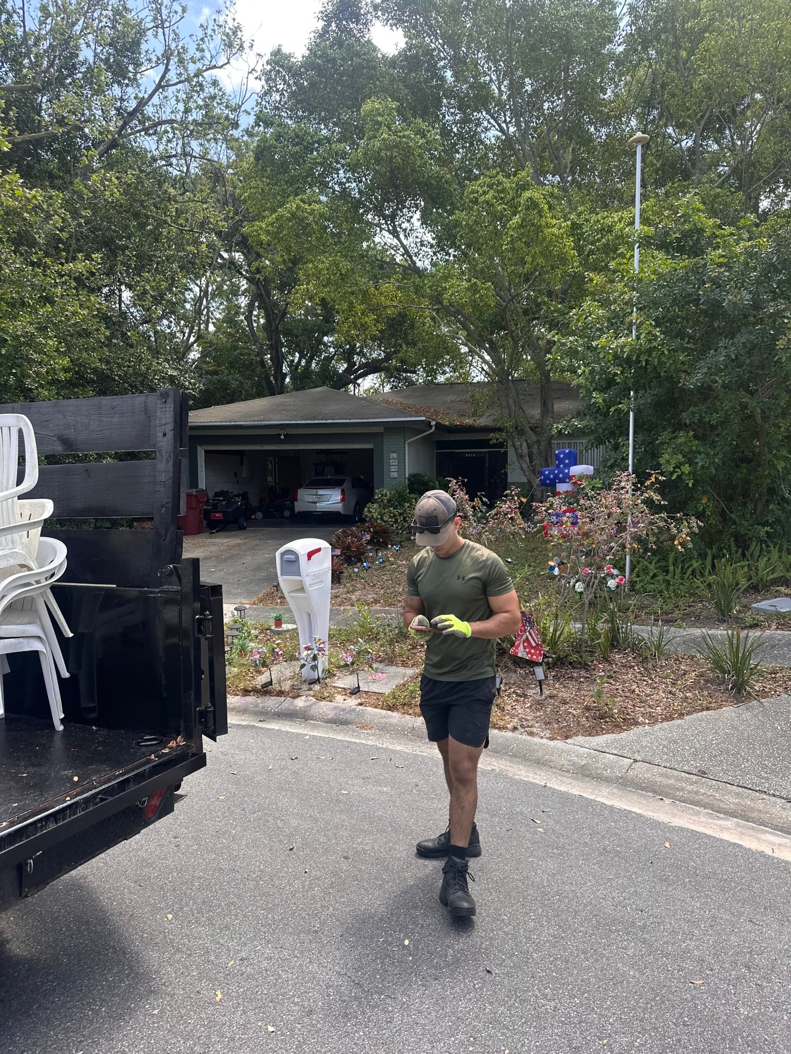 Junk Busters crew member beside a dump trailer during a Tampa Bay project