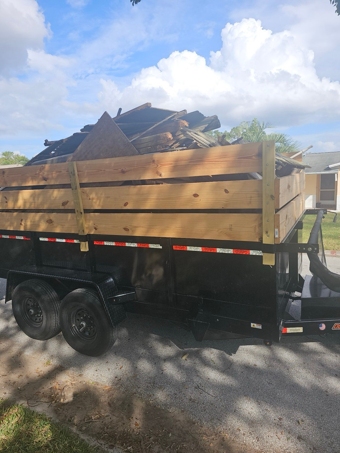 Junk Busters trailer loaded with wood and construction debris during a Tampa Bay cleanup